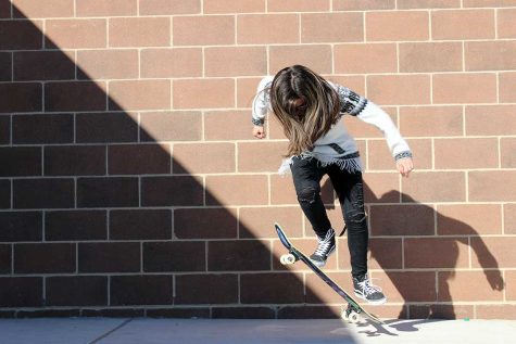 Sophomore Keixy Rosado practices her skateboarding moves during a portrait exercise in photojournalism class. “I skateboarded when I was little. I got frustrated, but I decided to try again,” she said.