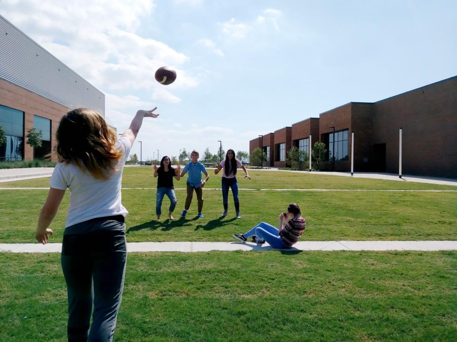 Students in Erin Cristales photojournalism class practice shooting perspective photos on the schools porch. While students can venture into areas such as the courtyards and porch with a teacher, they have so far not been allowed to visit the areas unattended.