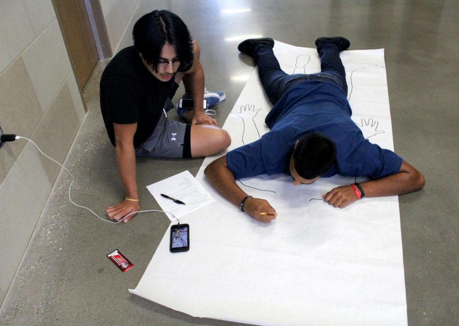 Seniors Luis Hernandez and Izac Contreras work on creating a diagram of human anatomy during fourth block.