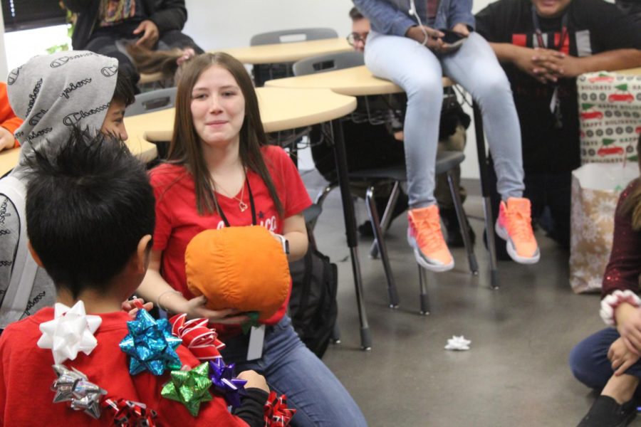 While some classes just open presents and play with toys, this Spanish class plays a learning game that has the child toss a pumpkin to an older student who would ask him to tell them a color to say in Spanish.