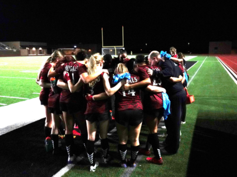Coach Jeff Miller huddles up with the 2022-23 girls varsity soccer team. Photo Courtesy of The Ambush Yearbook