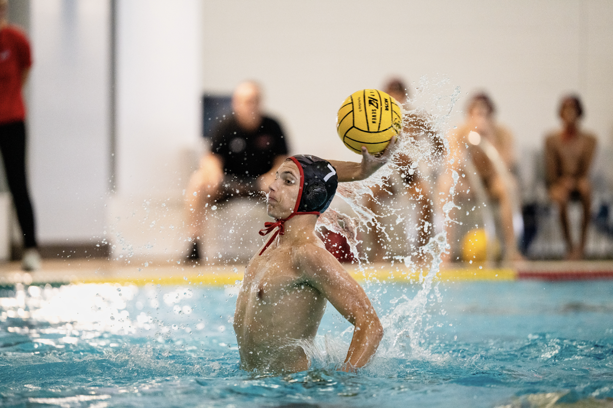 Cooper Naude reaches up to throw the water polo ball during a game as he helps lead his team to a district championship victory over rival Guyer. “It felt very exciting,” Naude said. “I was filled with extreme joy when I heard the news from my coach.”