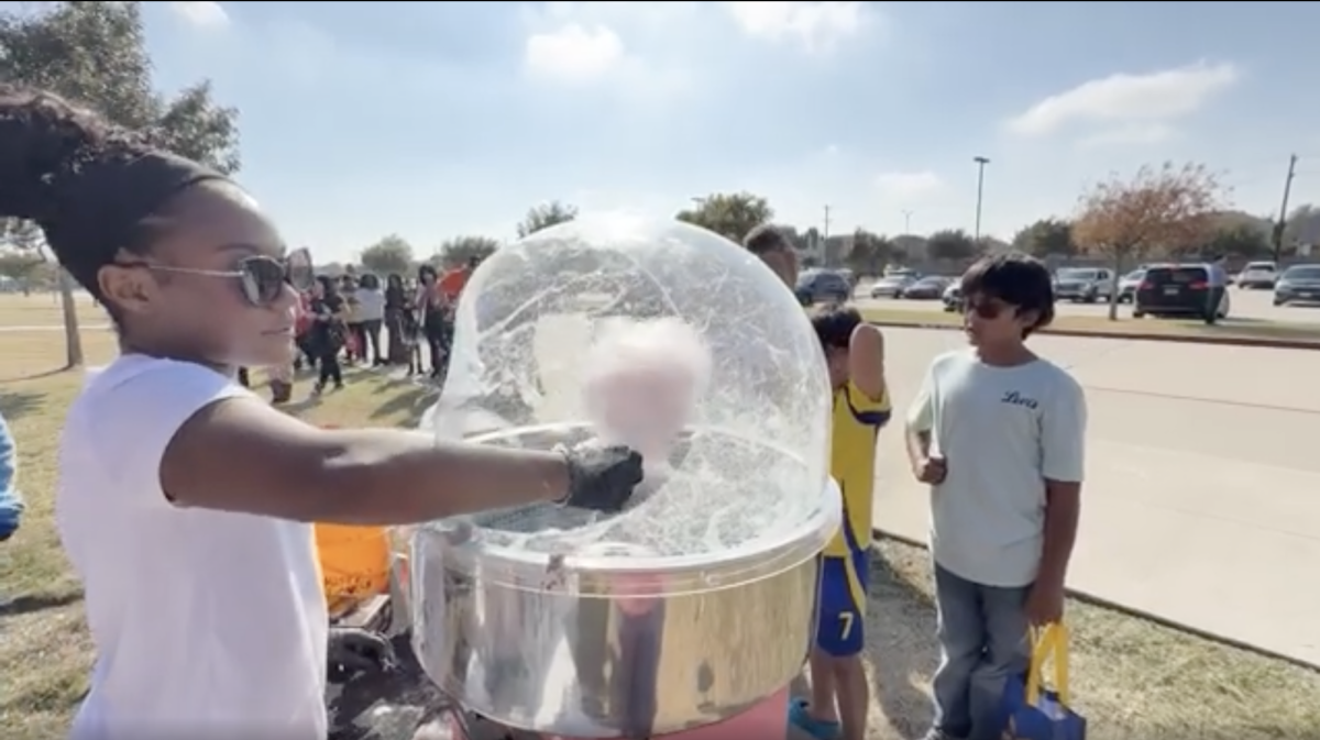 Kennedy Laster serves cotton candy with her business, Candy Curls, at student council's trunk or treat event to raise donations for the Braswell chapter of the Texas Association of Future Eductors (TAFE). Funds will be used to attend the state and national meets.