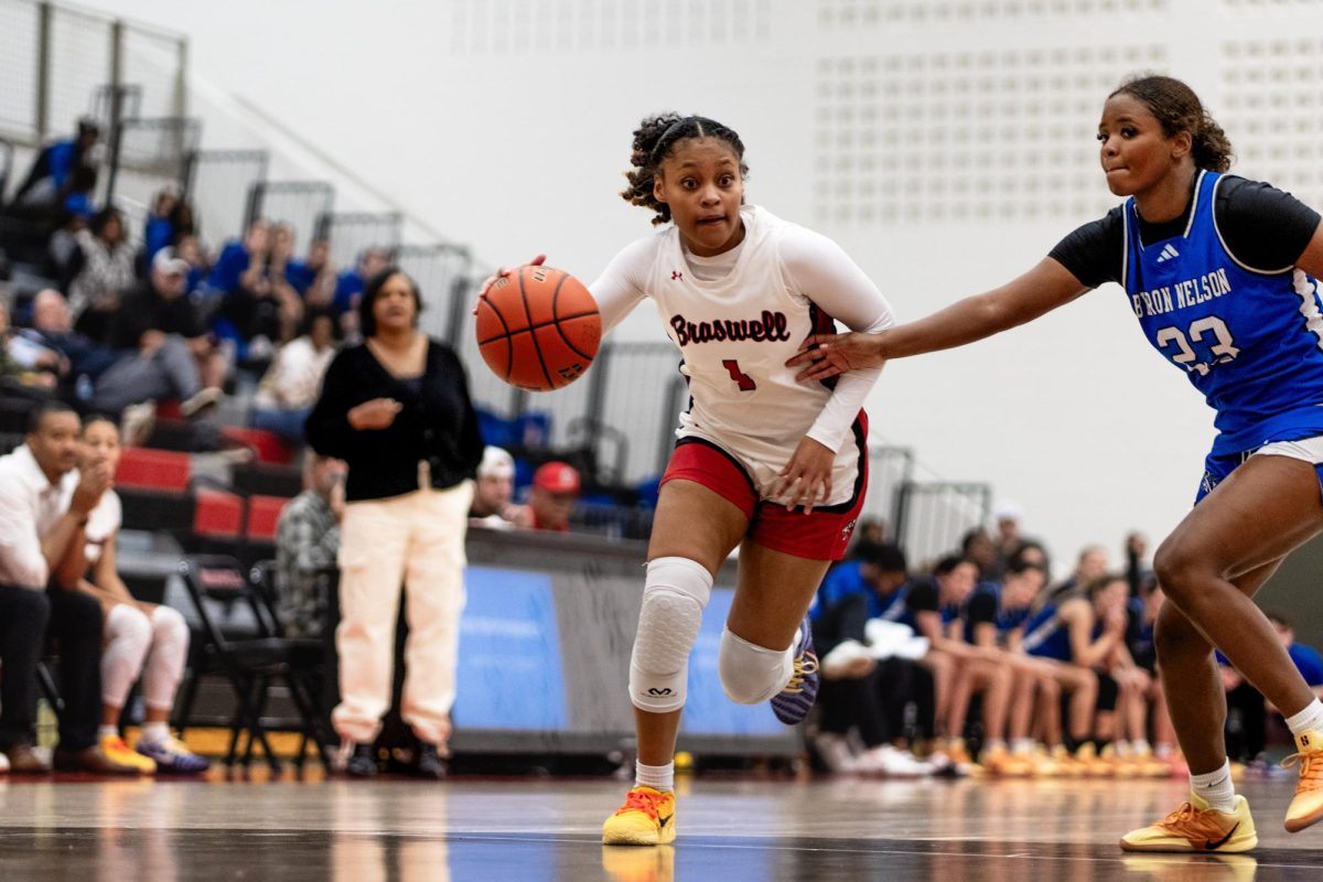 Kaya Thomas, 12, dribbles the ball down the court against Byron Nelson in a non-district game.