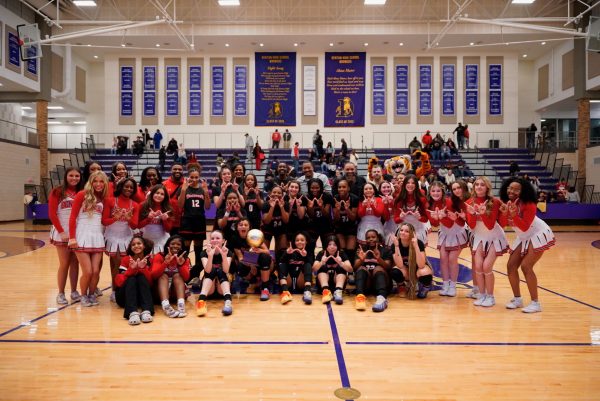 The Lady Bengals basketball team poses with the trophy after winning the regional semi-final game versus Byron Nelson.