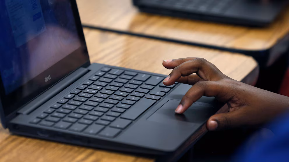 A student uses a chromebook to access educational content.
