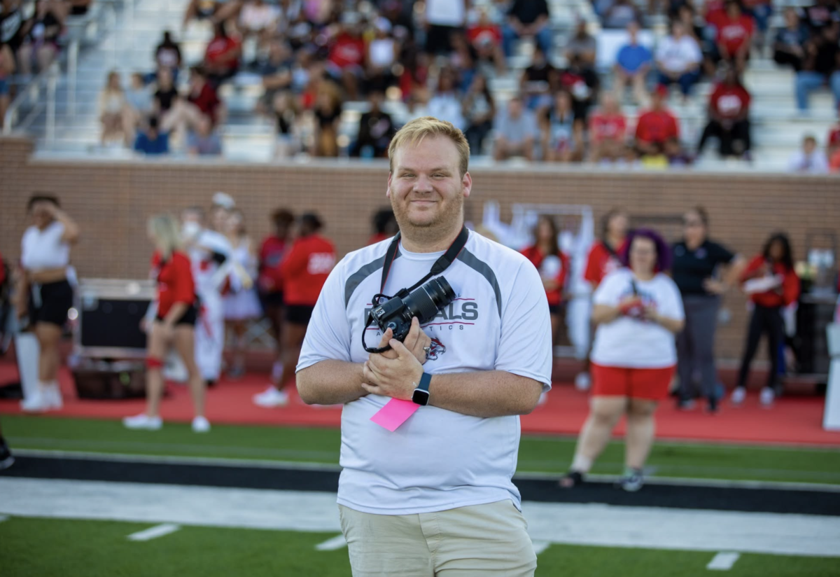Daniel Ryan Carr captured taking photos at a varsity football game set at Carrico Stadium in 2023. Photo Courtesy of Julie Lastovica